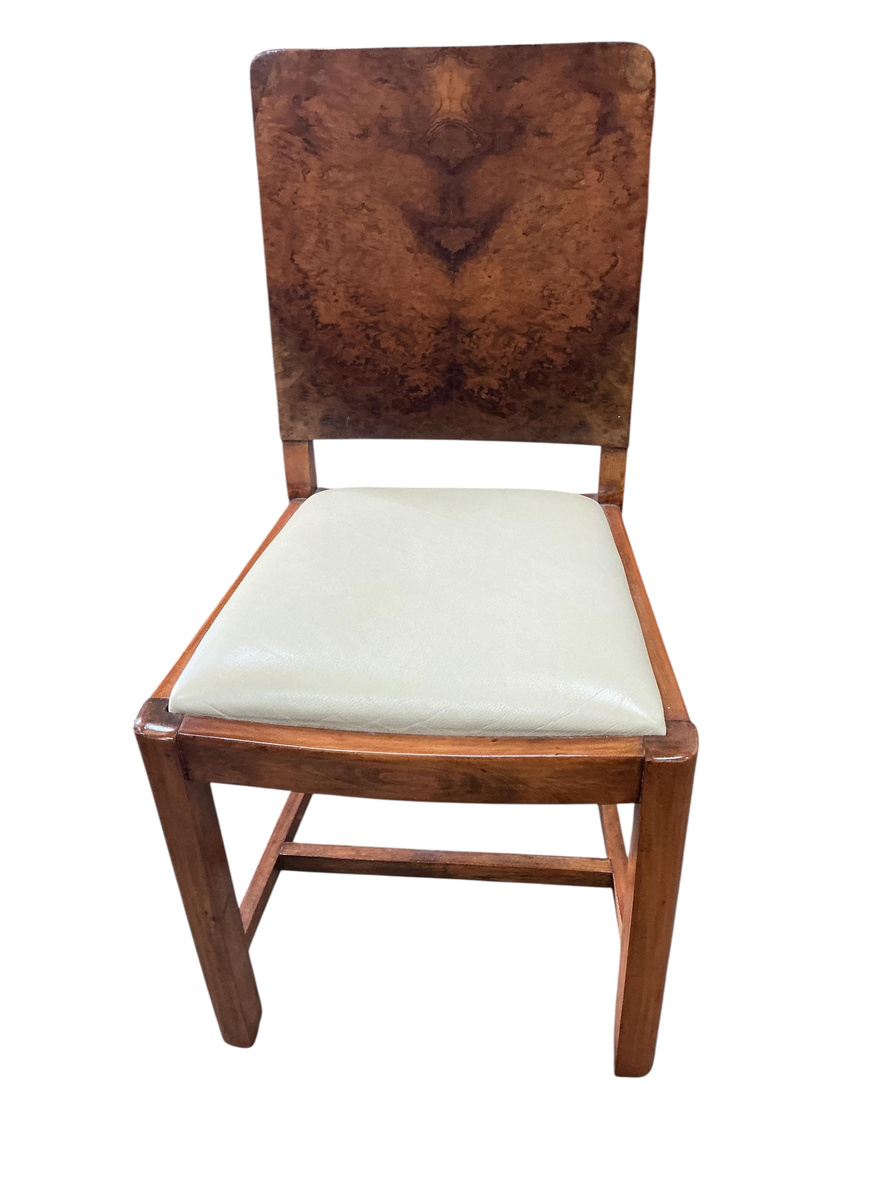 An Art Deco style rectangular walnut dining table, width 180cm, depth 94cm, height 75cm and six chairs